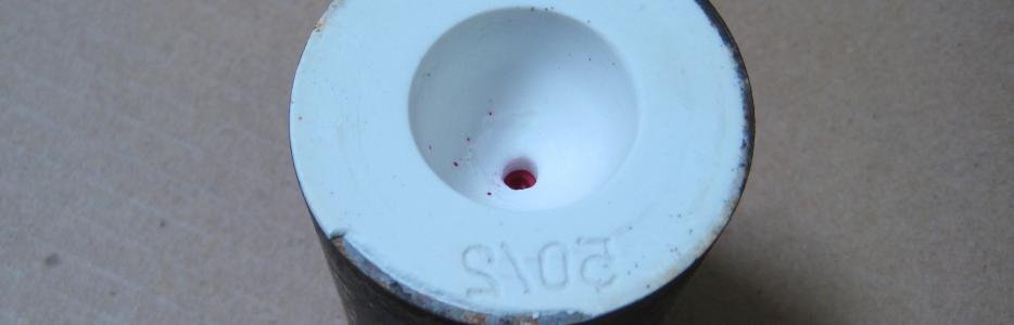 An image of a wax model, invested in plaster and ready for the burn out