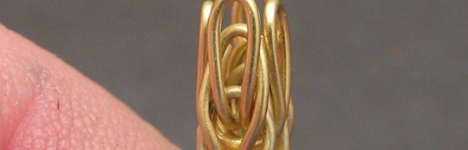 The first of the double-backed links in place and bent upwards to receive the next.