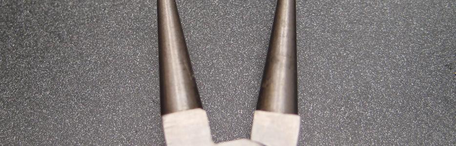The modified tips of a standard chain nosed pliers.