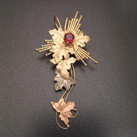 Pendant fabricated from multi-colored gold in an impressionistic form.