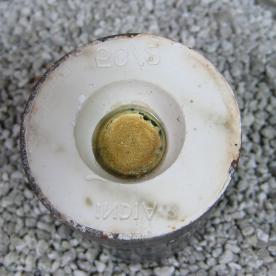 The cast and cooing gold sits within the still hot plaster mold.