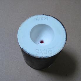 An image of a wax model, invested in plaster and ready for the burn out