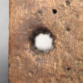 A closeup image of the chain hole used most often, showing the grooving caused by the links.