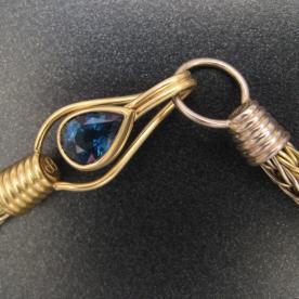 A closeup of a finished Roman Chain now mounted on a custom clasp and set with a fine Sapphire.