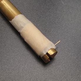 The wire has been wrapped around the mandrel and has been taped to hold it firm.