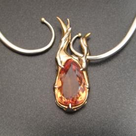 A precious imperial topaz set in 14K white and yellow gold.